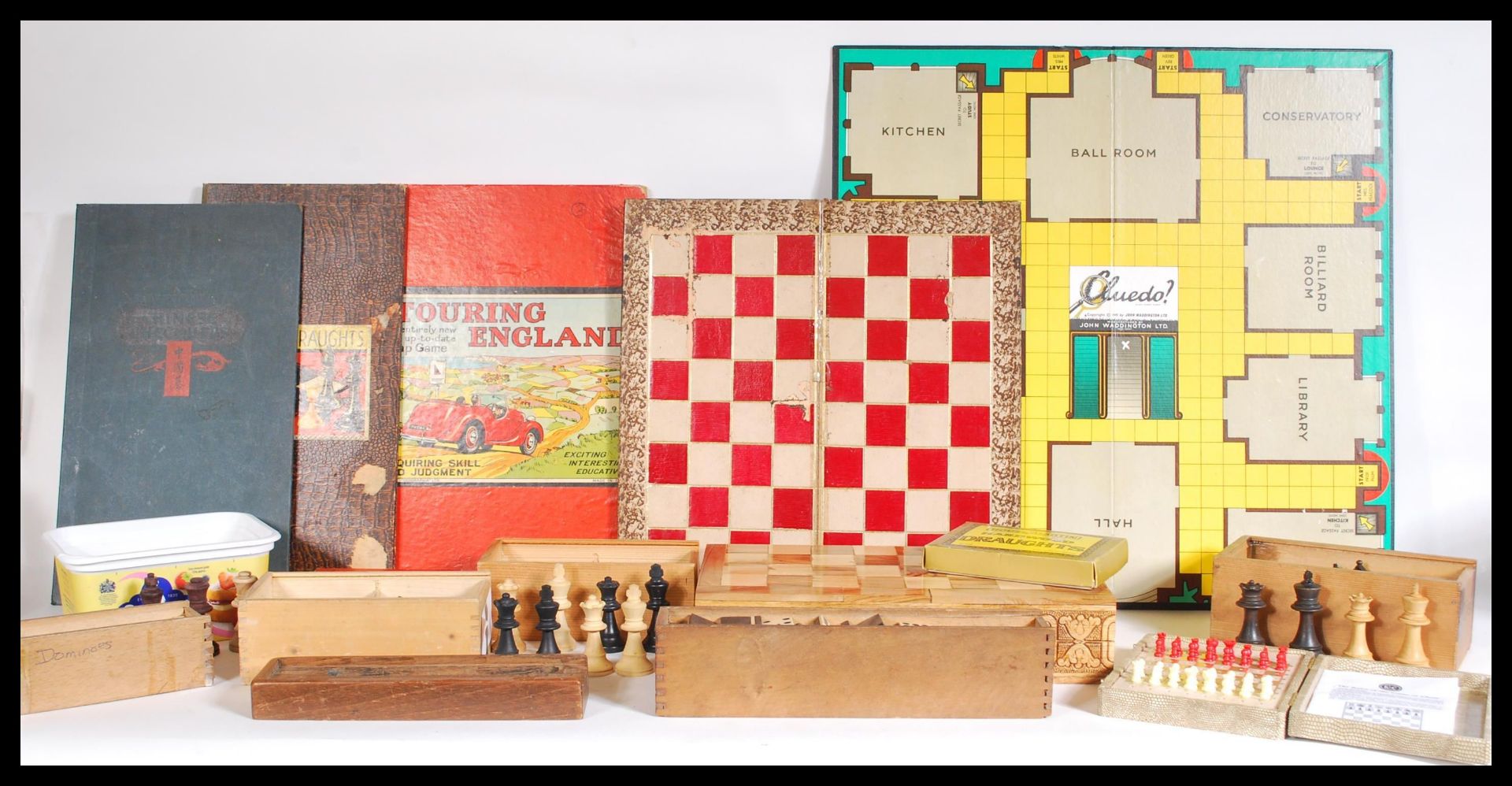 A compendium of vintage 20th Century chess pieces and draught sets, many cased sets with boards