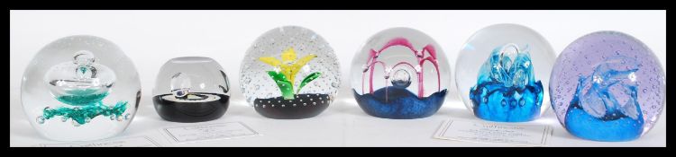A collection of six Caithness Scotland Glass paperweights complete in boxes to include Flower in the