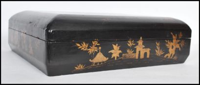 A late 19th century Chinese black lacquered and gilt games box with a detachable lid, enclosing five