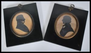 A pair of 19th Century portrait miniature silhouettes in original ebonised frames. One having