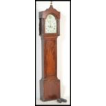 A early 20th Century mahogany long case clock having a shaped top with a brass eagle finial, with