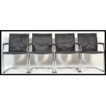 A set of 4 retro style chrome cantilever dining chairs with original black leatherette back and seat