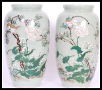 A pair of 19th Century Japanese vases having a mint green ground with hand painted details of