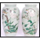A pair of 19th Century Japanese vases having a mint green ground with hand painted details of