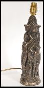 A 20th Century bronze effect resin lamp stand in the form of Asian deities with animal companions