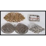 A collection of vintage Art Deco belt buckles to include rhinestone examples, brass scrolled example