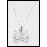 A sterling silver CZ and opal set necklace pendant in the form of a cat mask set to sterling