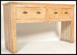 A large 19th Century Victorian country scrubbed pine dresser base, having two deep drawers fitted