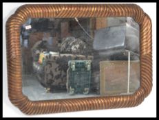 A large early 20th Century overmantel mirror having a central glass panel with gadrooned gilt frame.