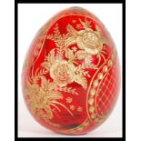 A vintage 20th Century Russian cranberry red glass egg having beautiful hand gilded decoration