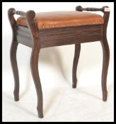 An early 20th Century Edwardian mahogany piano stool, with end raised handles, over cupboard base,