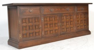 A large 20th Century Jacobean revival sideboard dresser base, having a long central drawer flanked