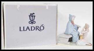 A Lladro ceramic figure entitled Cinderella and The Fairy Godmother 07553 complete in original