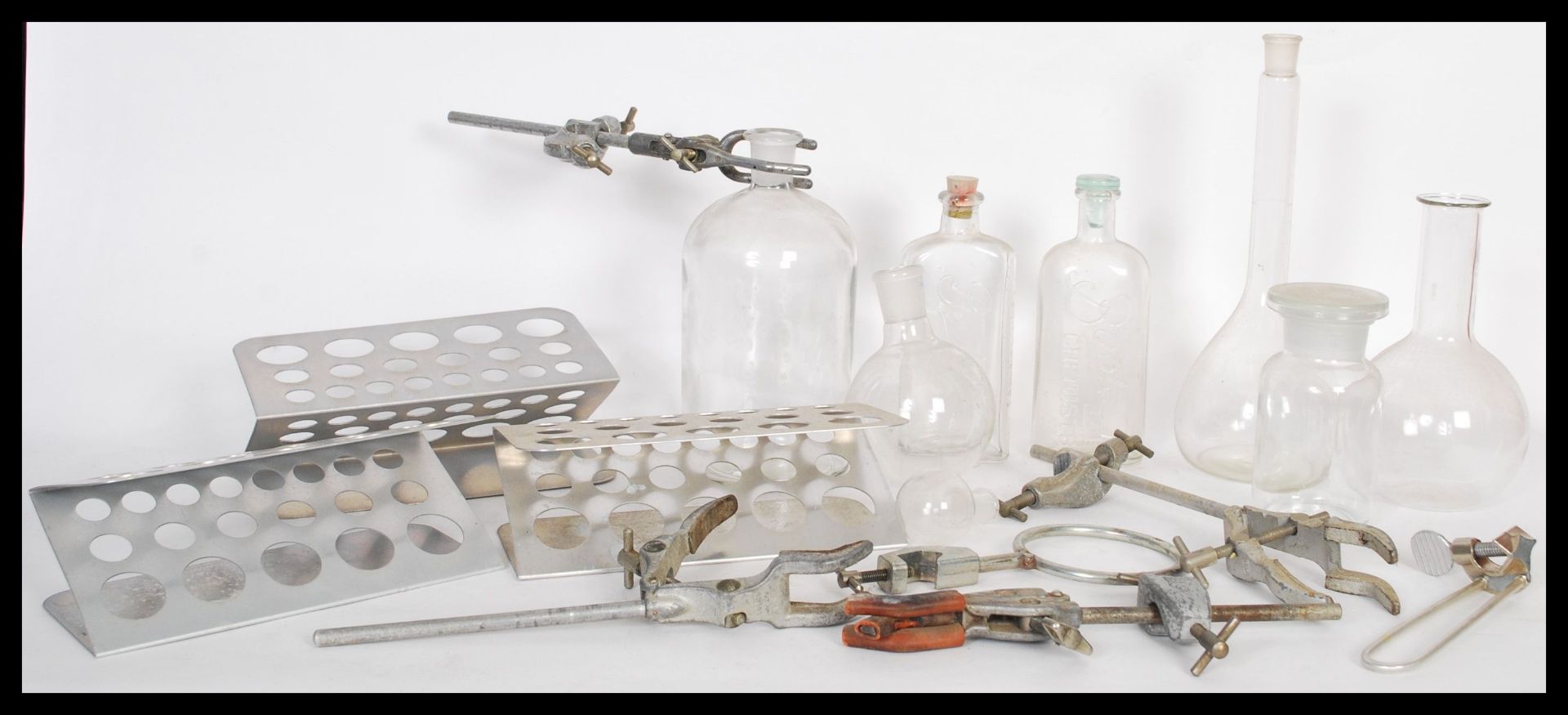 A selection of vintage scientific equipment to include petri dish stands, clamps, glass bottles