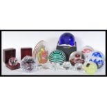 A collection of assorted 20th Century glass paperweights to include Swarovski, Wordsley, Langham,