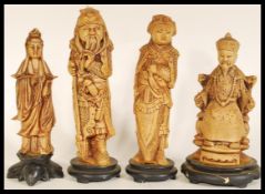 A set of four Chinese figurines of elders raised on socle bases comprising of Goddess of Mercy,