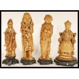 A set of four Chinese figurines of elders raised on socle bases comprising of Goddess of Mercy,