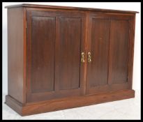 A 19th Century Victorian mahogany school cupboard having twin panelled doors fitted with brass