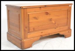 An antique style country pine blanket box coffer chest having a hinged lid opening to reveal a