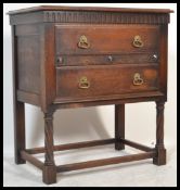 An Edwardian oak Jacobean revival chest of drawers on stand. The two drawers with carved detailing