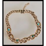 A stamped 15ct curb link bracelet set with turquoise stones and seed pearls. Total weight 13.8g.