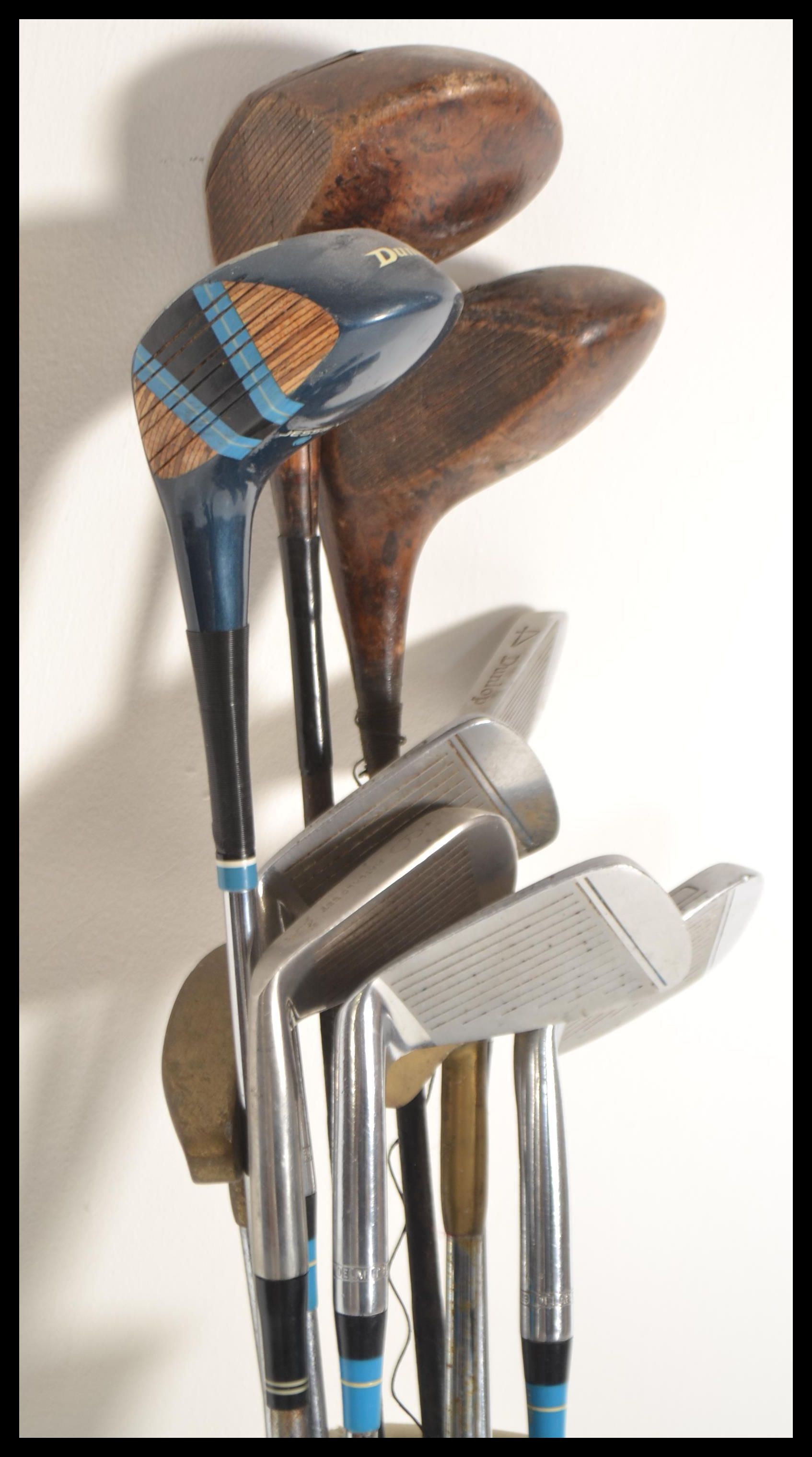 A set of vintage 20th Century golf clubs to include irons, woods etc. All contained within a slim