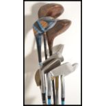 A set of vintage 20th Century golf clubs to include irons, woods etc. All contained within a slim