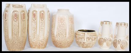 A collection of Bretby 19th / early 20th Century Clanta pattern ceramics in a light cream glaze to