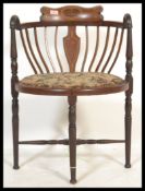 An Edwardian mahogany and marquetry inlaid corner chair / armchair being raised on turned legs