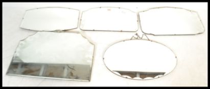 A collection of five vintage early 20th Century Art Deco frameless mirrors of scalloped form.