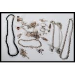 A collection of 925 silver jewellery to include a silver charm bracelet strung with 12 charms