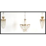 A set of three 20th century gilt metal ormolu rococo empire revival chandeliers, each with faceted