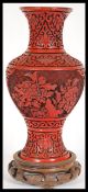An early 20th Century Chinese Cinnabar Lacquer vase of baluster form having deep carved decoration