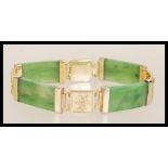 A vintage 20th Century Chinese jade bracelet having yellow metal character mark spacers and hidden
