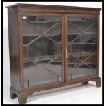 An early 20th century Chippendale revival bookcase library display cabinet having two glazed twin