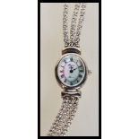A ladies silver Precious Time Quartz wrist watch having an oval case with a mother of pearl face,