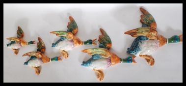 A set of five 1930's Art Deco Beswick graduating ceramic wall plaques in the form of flying ducks.