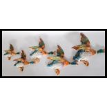 A set of five 1930's Art Deco Beswick graduating ceramic wall plaques in the form of flying ducks.