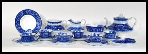 A 19th Century Victorian Staffordshire Flow Blue tea service consisting of teapot, cups, saucers