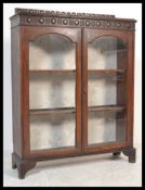 A late 19th century Victorian glazed bookcase / display cabinet having twin glass panel doors
