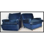 A pair of retro 20th Century circa 1960's G Plan armchairs, upholstered in a rich blue velvet