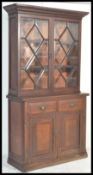 A Victorian 19th century mahogany library bookcase cabinet. Raised on a plinth base with double door