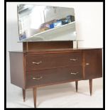 A vintage mid 20th Century dressing table, two long drawers fitted with shaped brass handles flanked