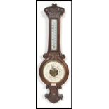 A good early 20th Century oak mounted milk glass facia mercury column carved banjo barometer, glazed