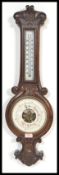 A good early 20th Century oak mounted milk glass facia mercury column carved banjo barometer, glazed