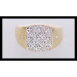 An 18ct gold ring having a square head set with white stones within a lattice pattern. Weight 8.