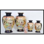 A set of four graduating 20th Century Japanese vases having cream hand painted narrative panels on a