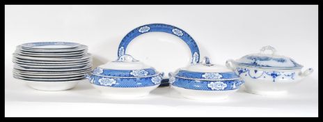 An early 20th Century blue and white part dinner service to include plates and lidded tureens,