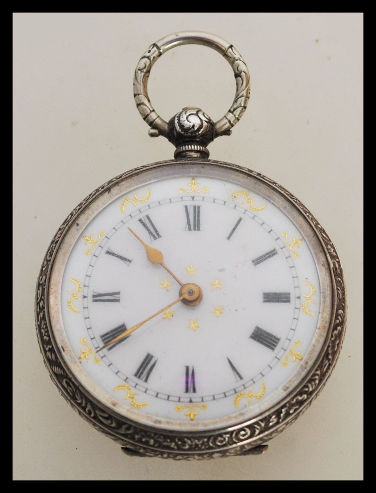 An early 20th Century continental silver fob pocket watch having engraved foliate decoration to