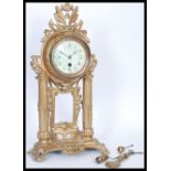 A 19th Century French ormolu gilt brass Portico clock having a white enamel face with detailed